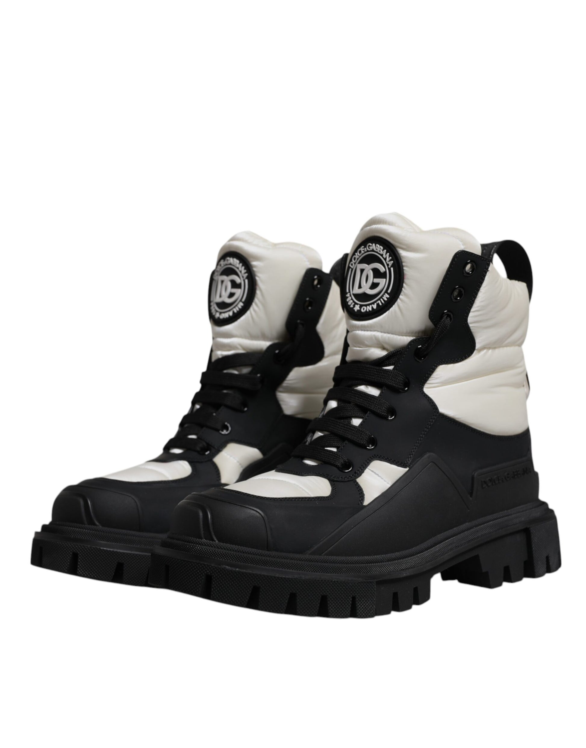 Pair of black and white boots with laces and a logo on the side