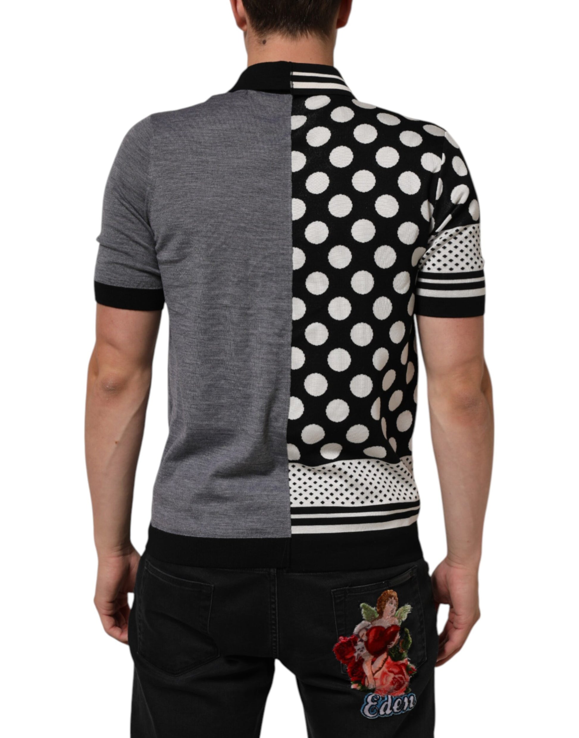 Man wearing a gray shirt with black polka dots on one side and white polka dots on the other side