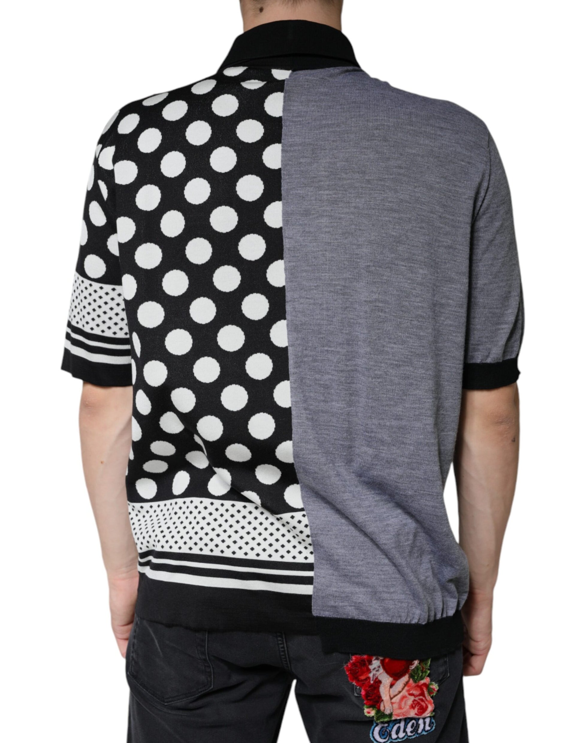 Man wearing a polka dot shirt over a gray sweater vest