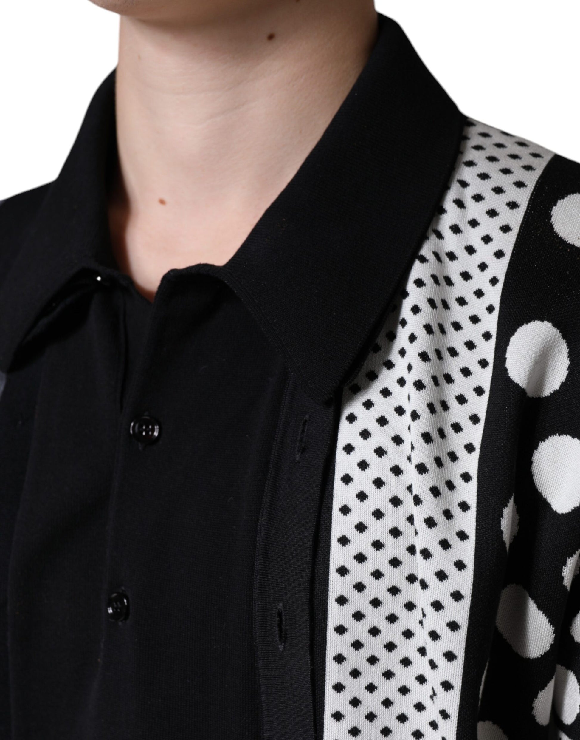 Black shirt with polka dot vest over it