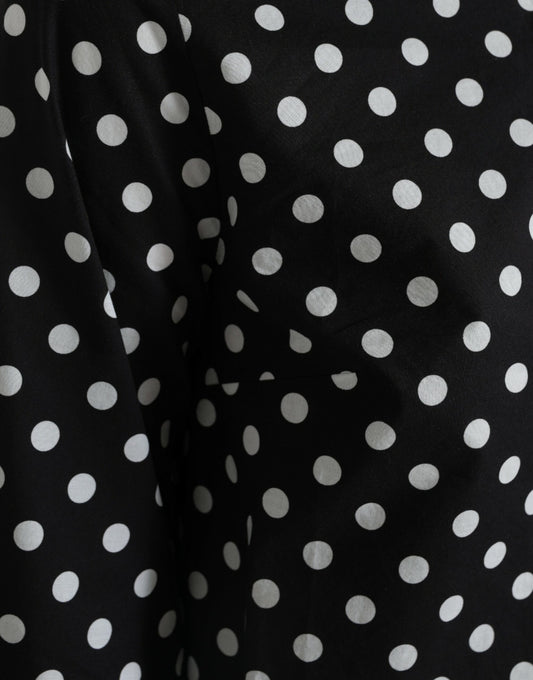 A black dress with white polka dots, featuring a nylon material and a shift style