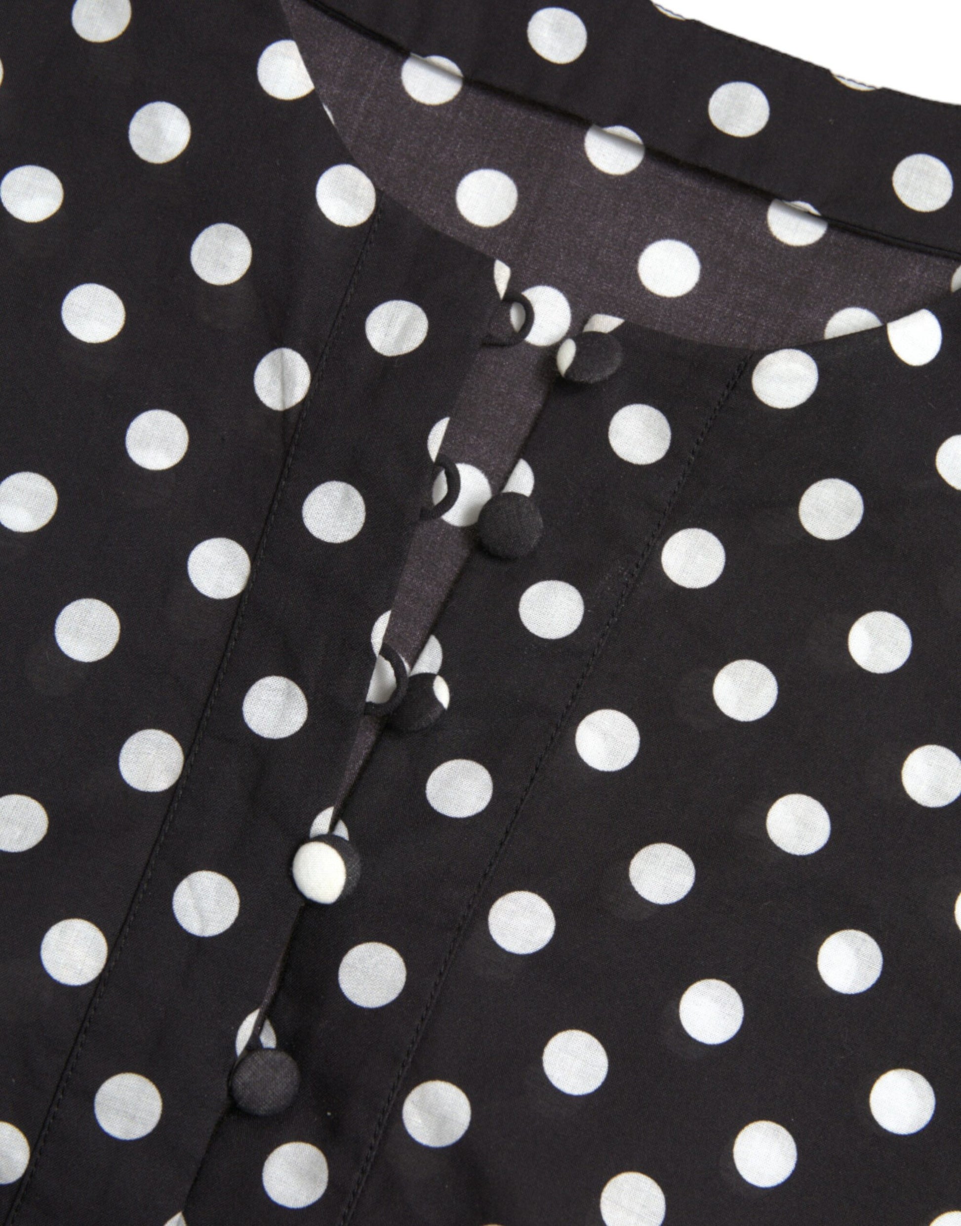 A black mini dress with white polka dots and nylon material