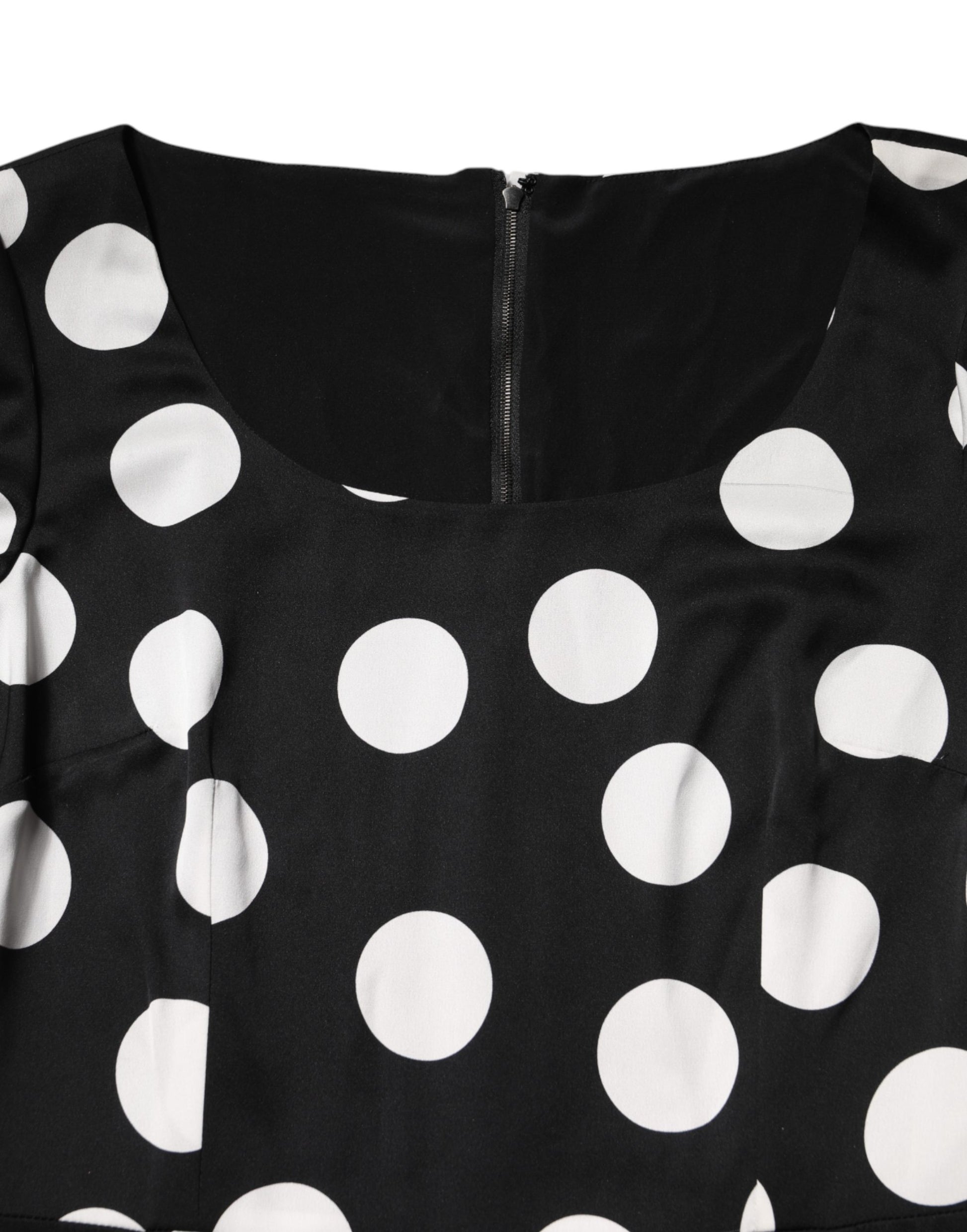 A black midi dress with white polka dots, made of silk