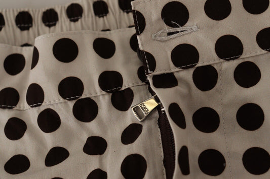Pair of women's pants with black polka dots on a beige background