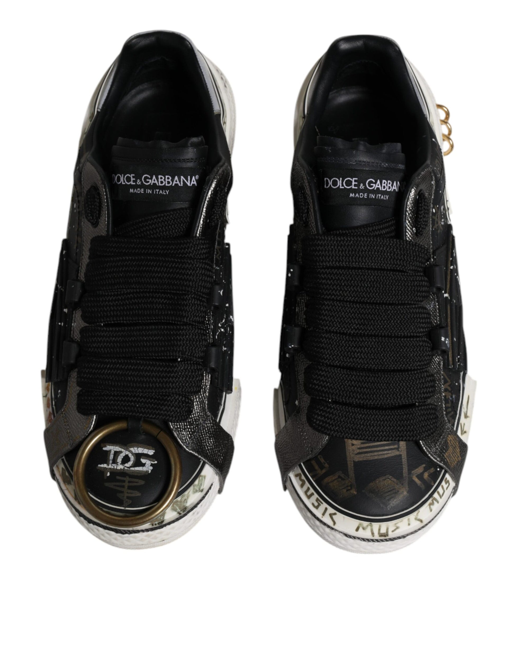 Pair of black and white sneakers with gold accents, featuring a unique design on the side