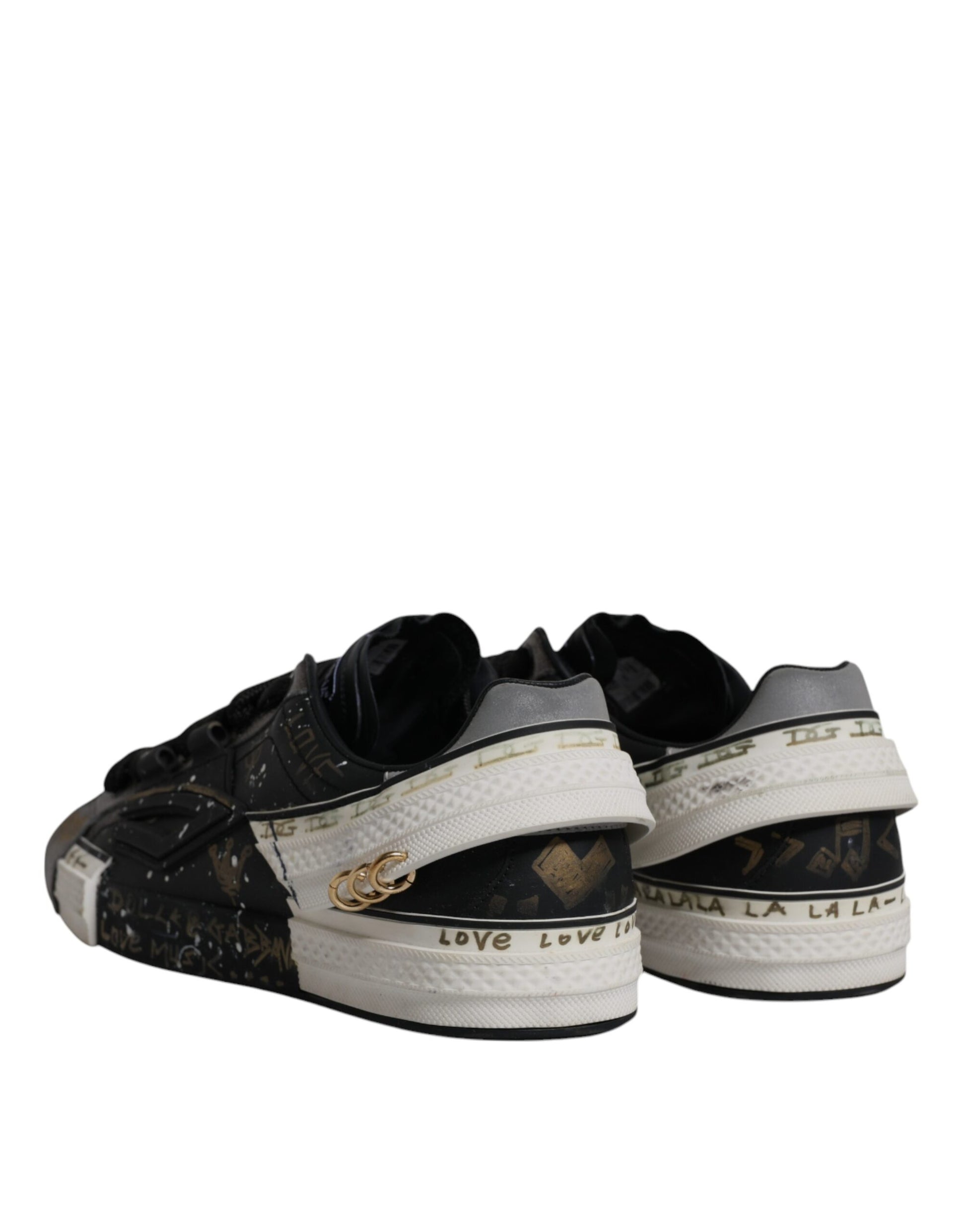 Pair of black and white sneakers with gold accents, featuring the Dolce & Gabbana logo