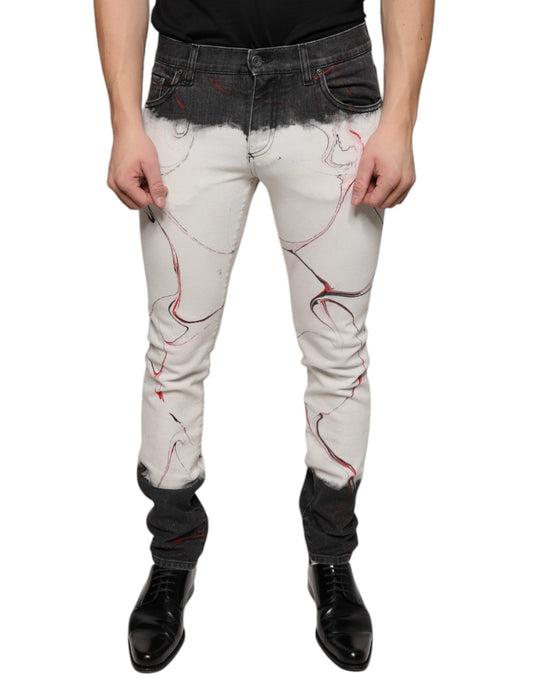 Man wearing distressed jeans with red and black designs
