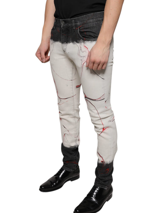 Man wearing distressed jeans with red paint splatters