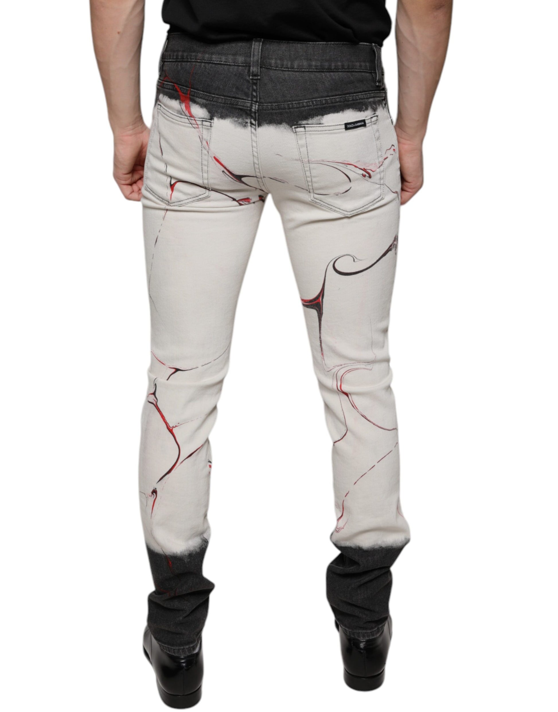 Pair of distressed jeans with red splatter design