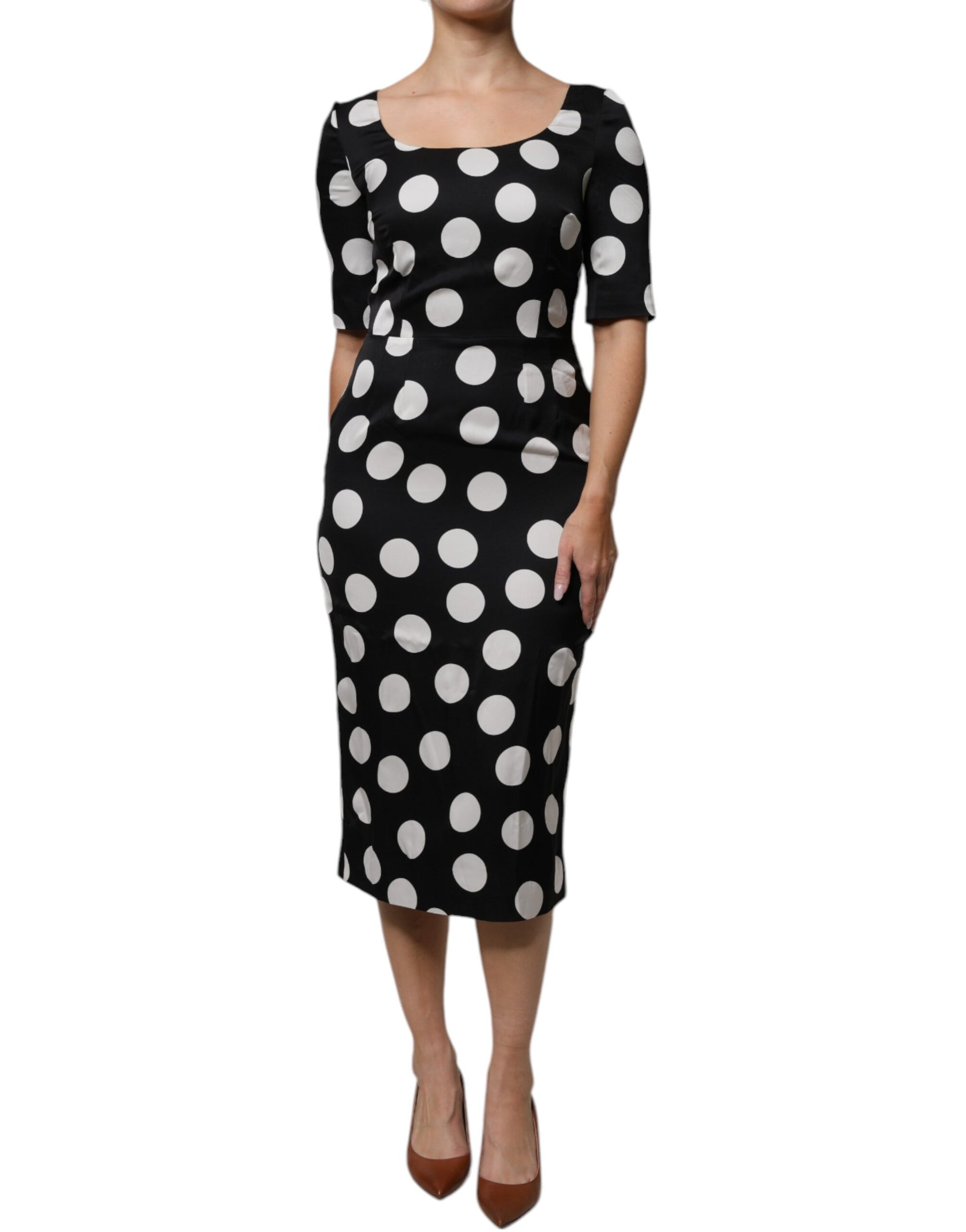 A black midi dress with white polka dots, made of silk