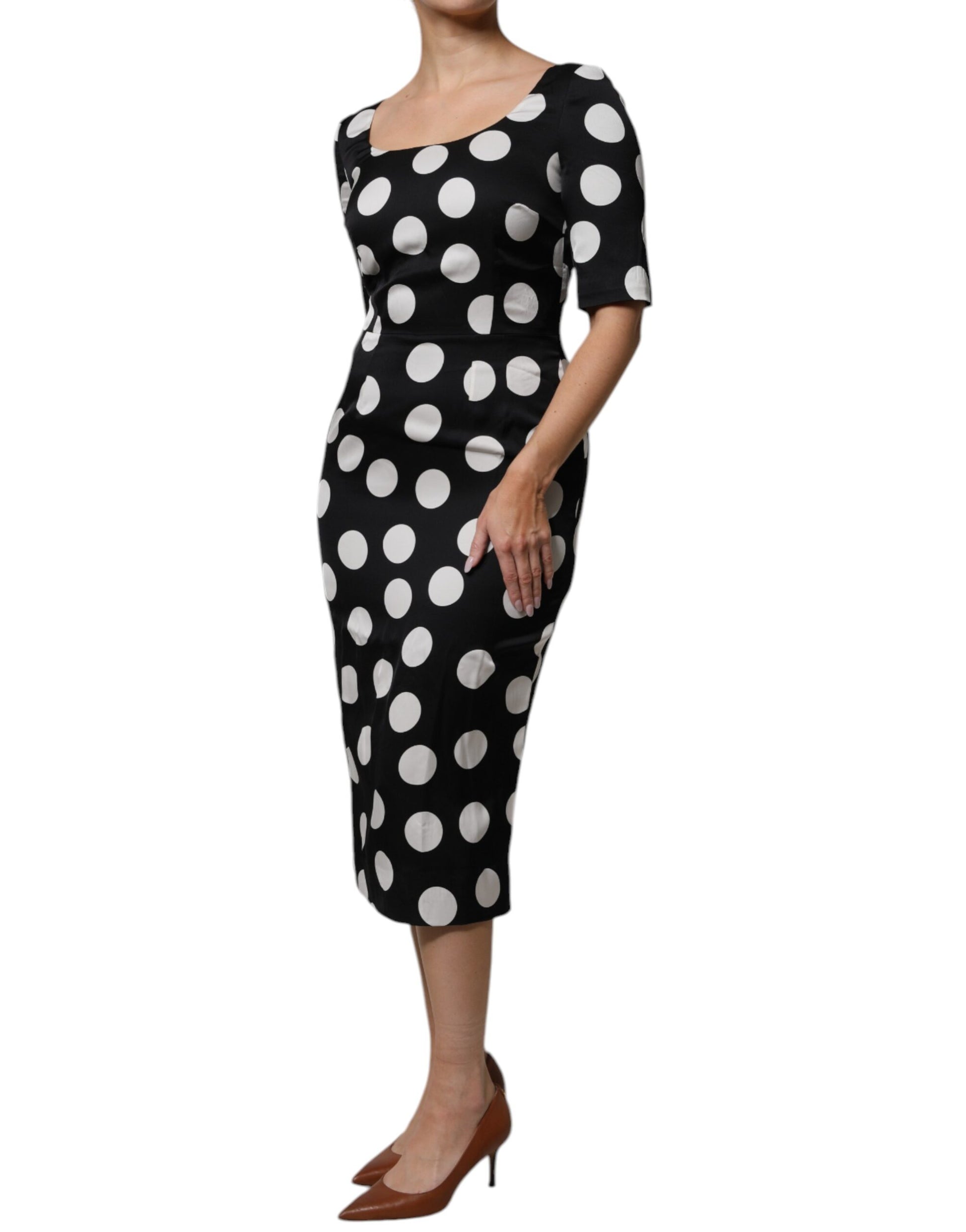 A black midi dress with white polka dots, made of silk