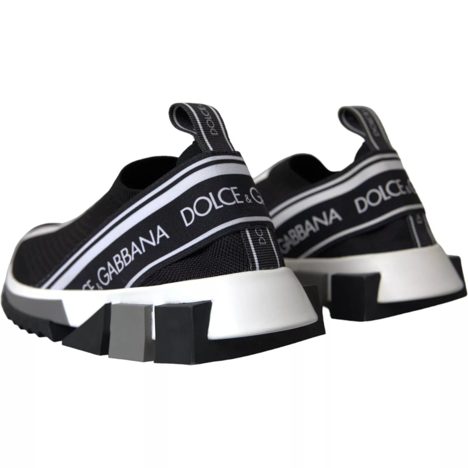 Pair of black sneakers with white soles and a logo on the side