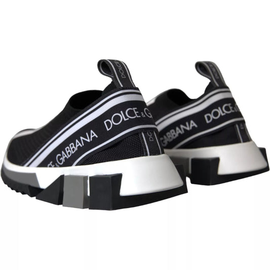 Pair of black sneakers with white soles and a logo on the side