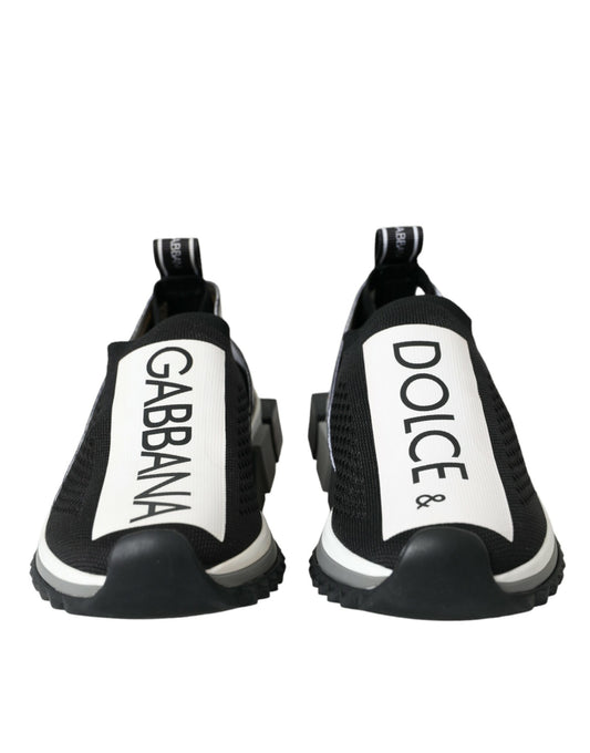 Pair of black sneakers with white soles and brand names on sides