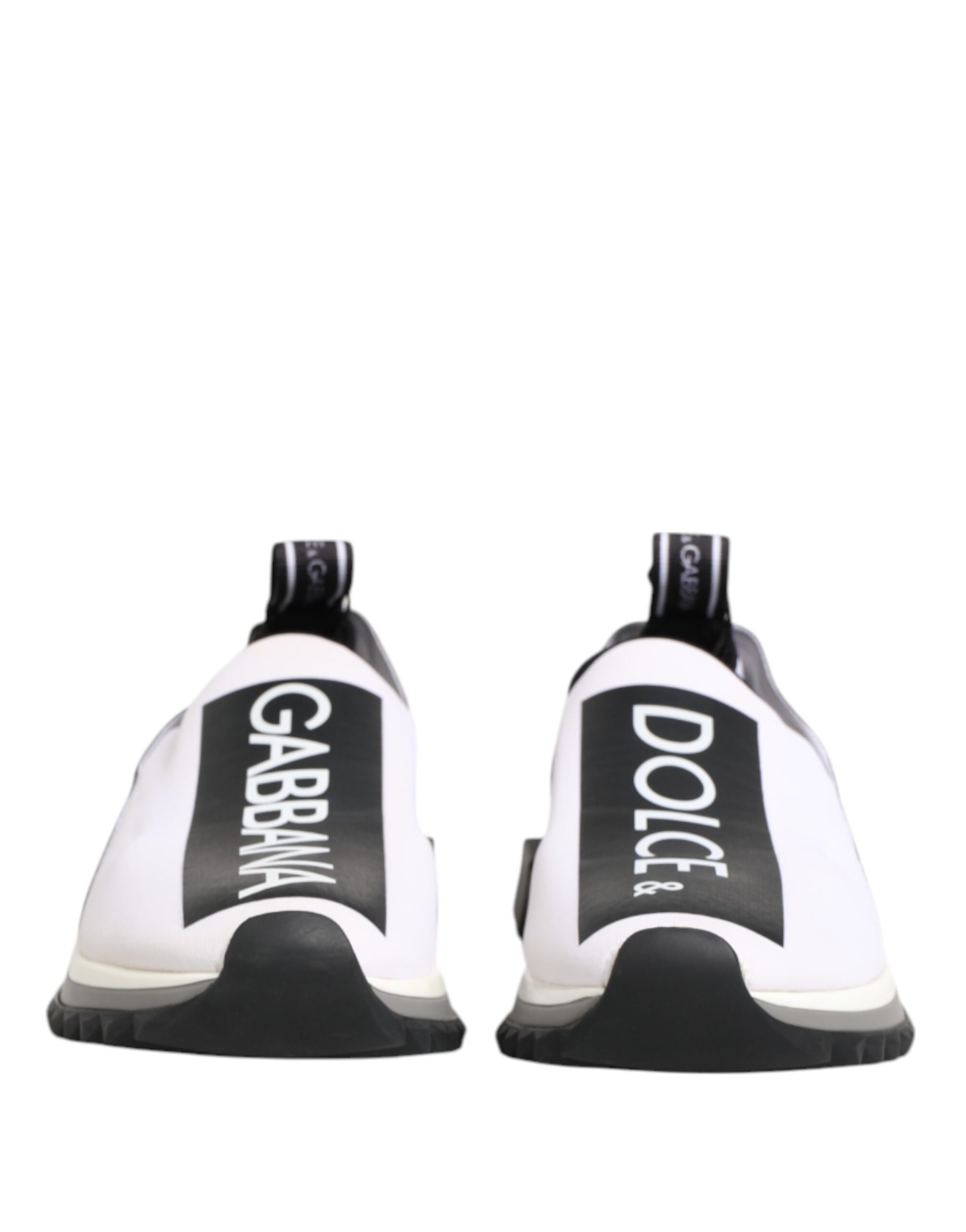 Pair of black and white slip-on shoes with brand name on side