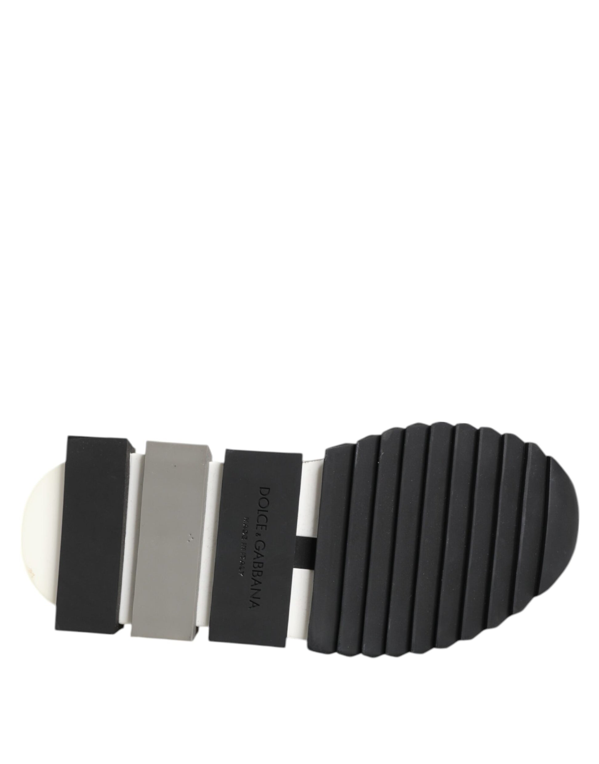 A black and white slip-on shoe with a textured sole, featuring the Dolce & Gabbana logo