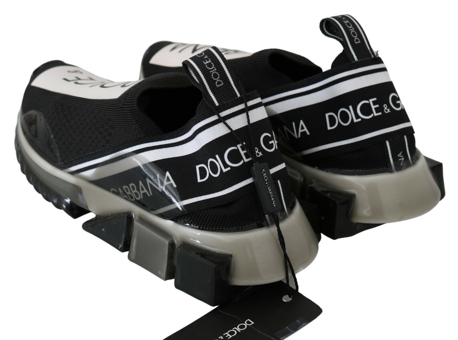 Pair of black and white sneakers with brand name on side