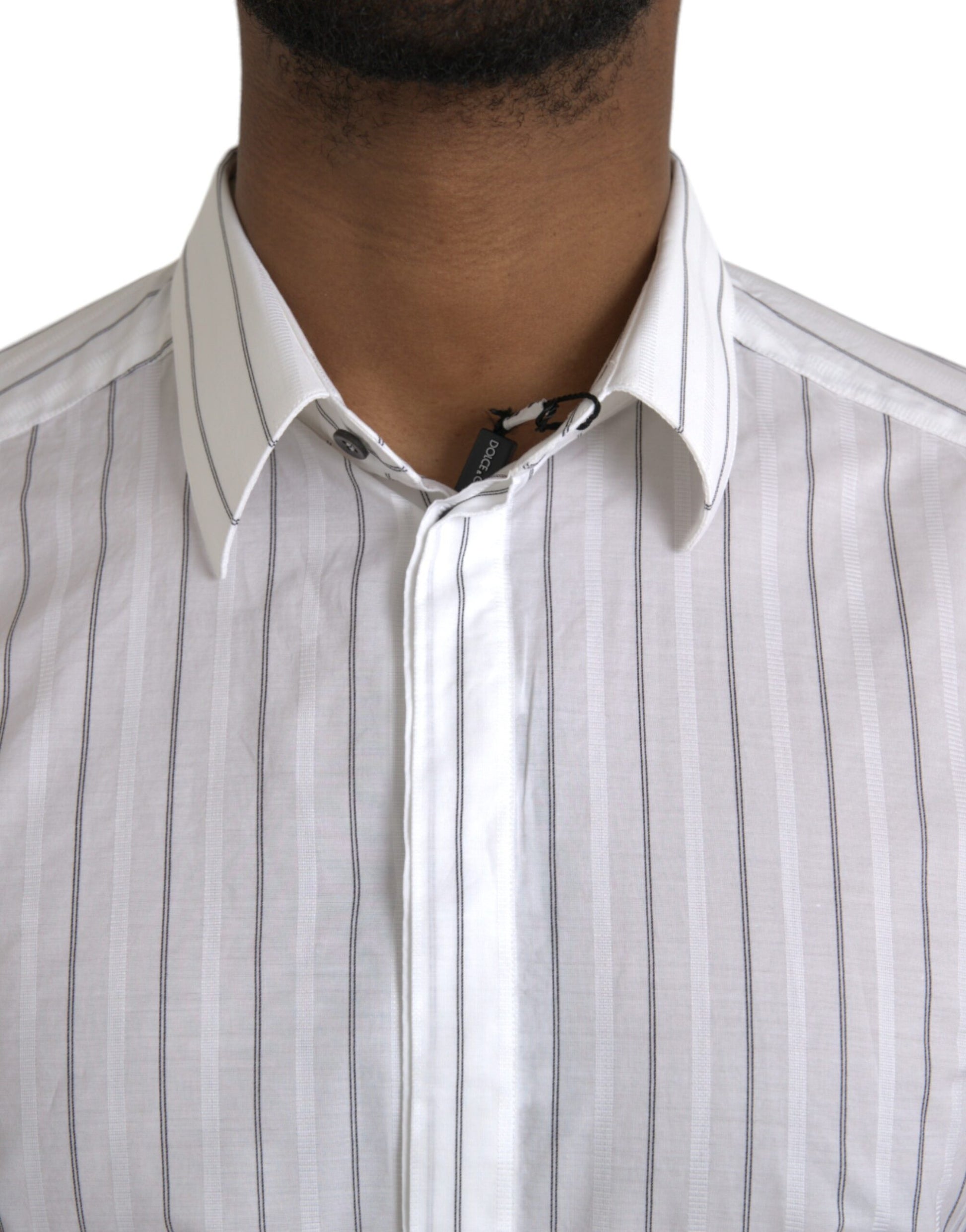 A black and white striped shirt with a gold necktie