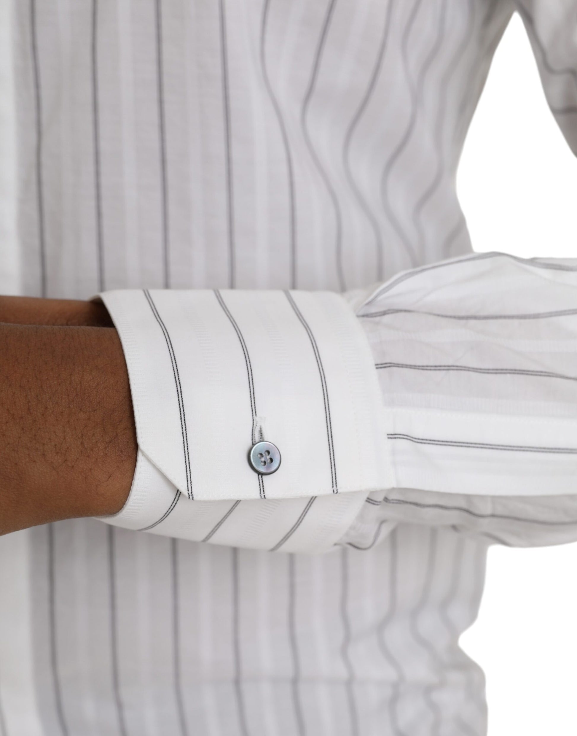 A black and white striped shirt with a gold button
