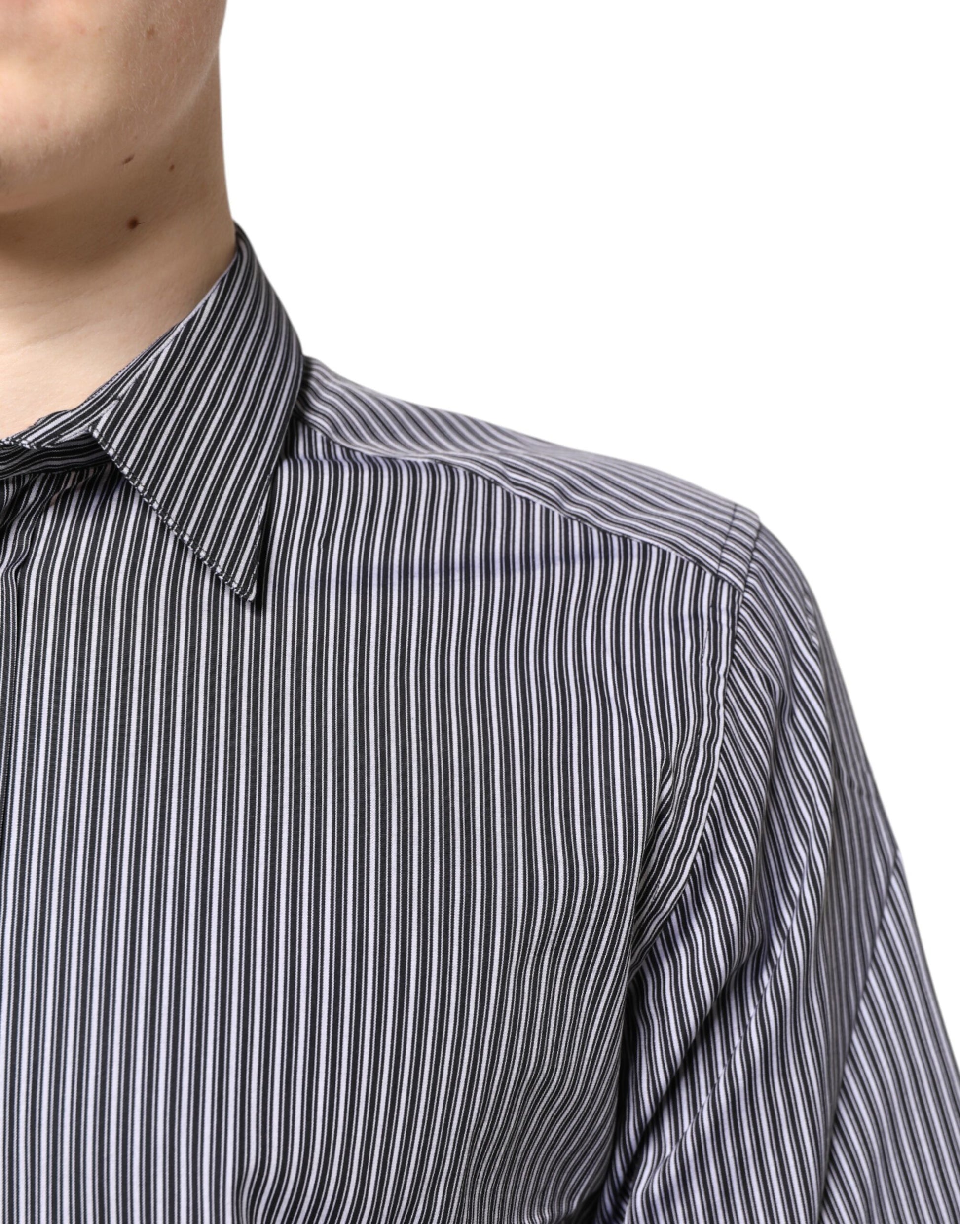 A black and white striped formal dress shirt with a gold accent