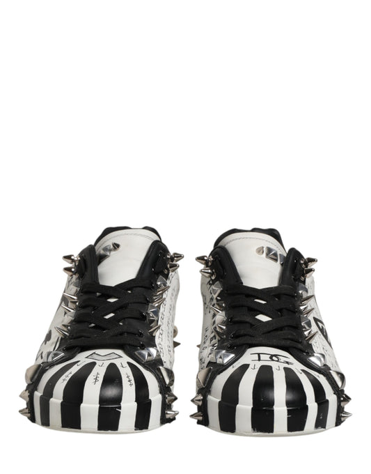 Pair of black and white striped shoes with spikes on the bottom
