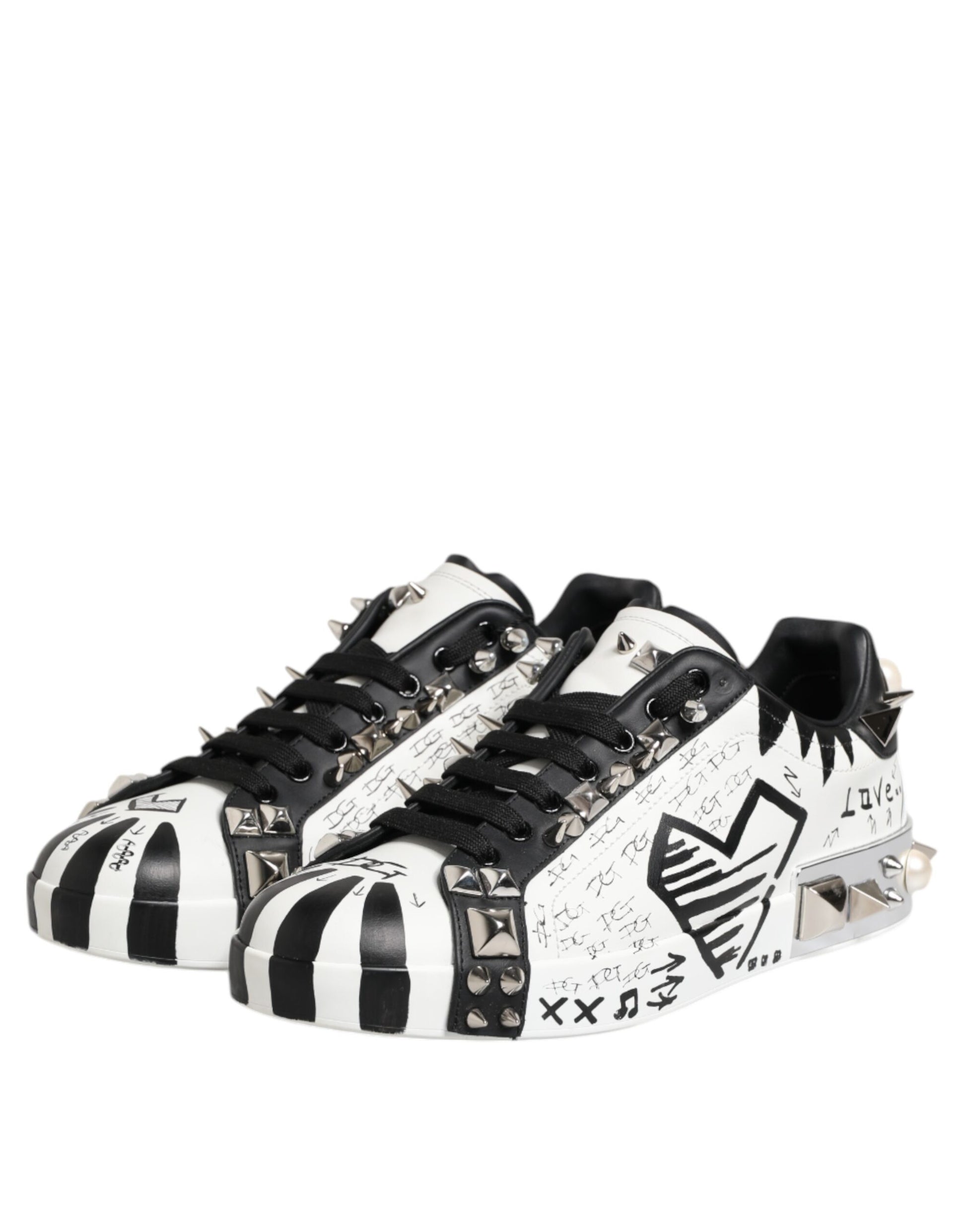 Black and white studded low top sneakers with a heart design on the side