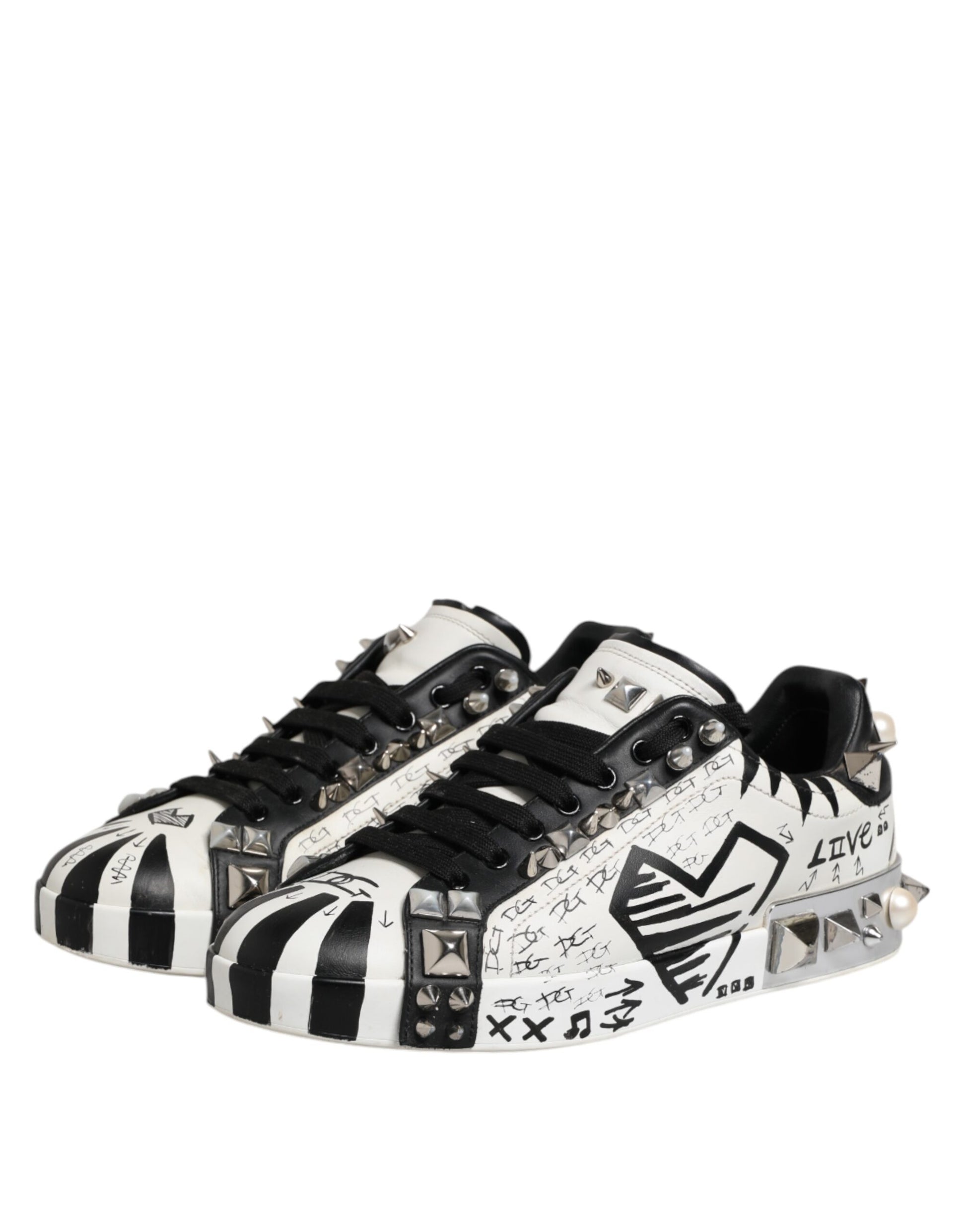 A pair of black and white studded low top sneakers with a unique design featuring the D&G logo