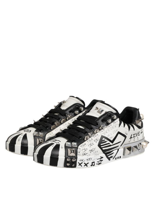 A pair of black and white studded low top sneakers with a unique design featuring the D&G logo