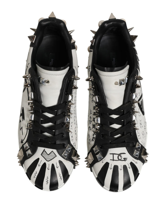 Pair of black and white sneakers with spikes on the sides