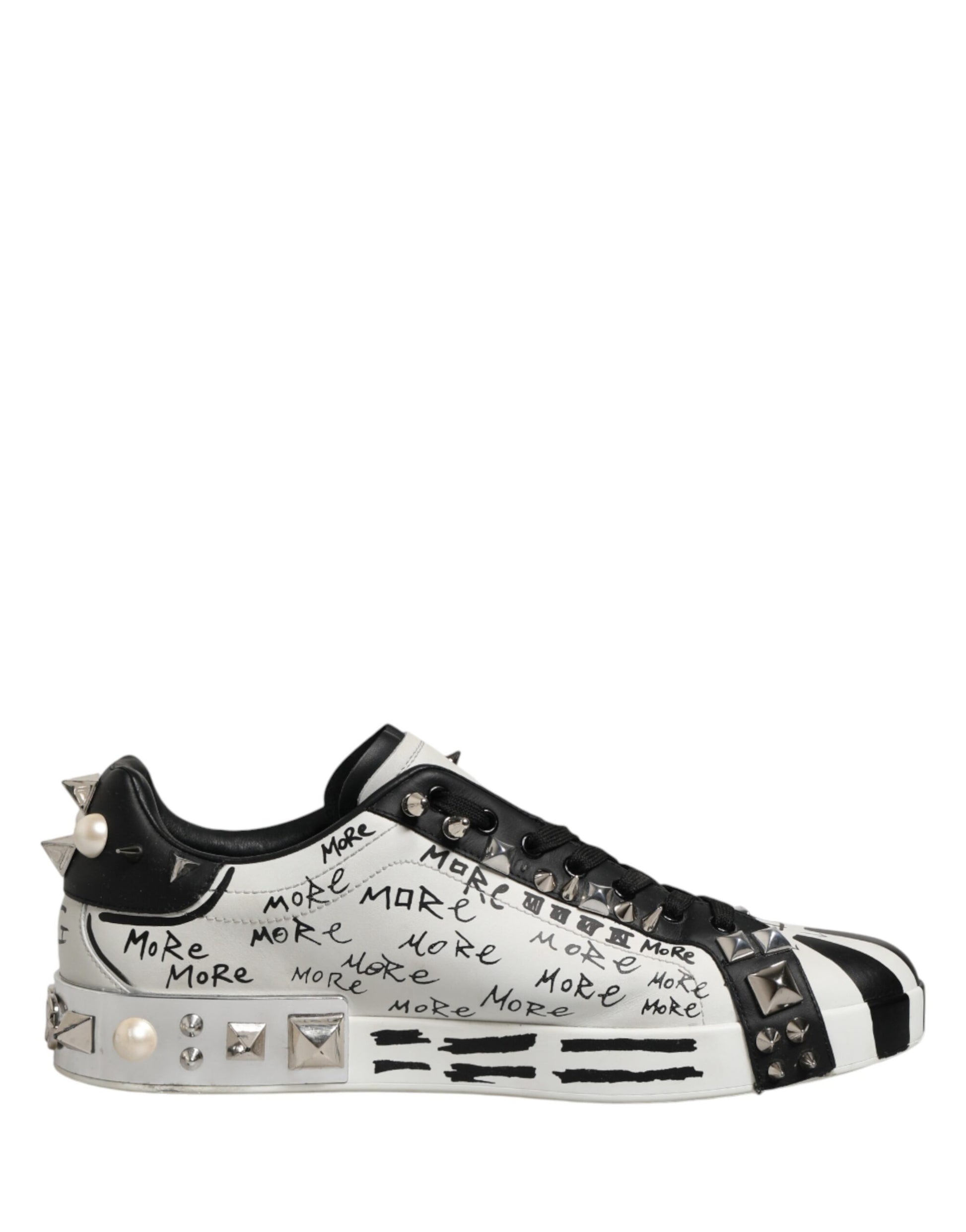 Black and white sneaker with "make more make more" written on side