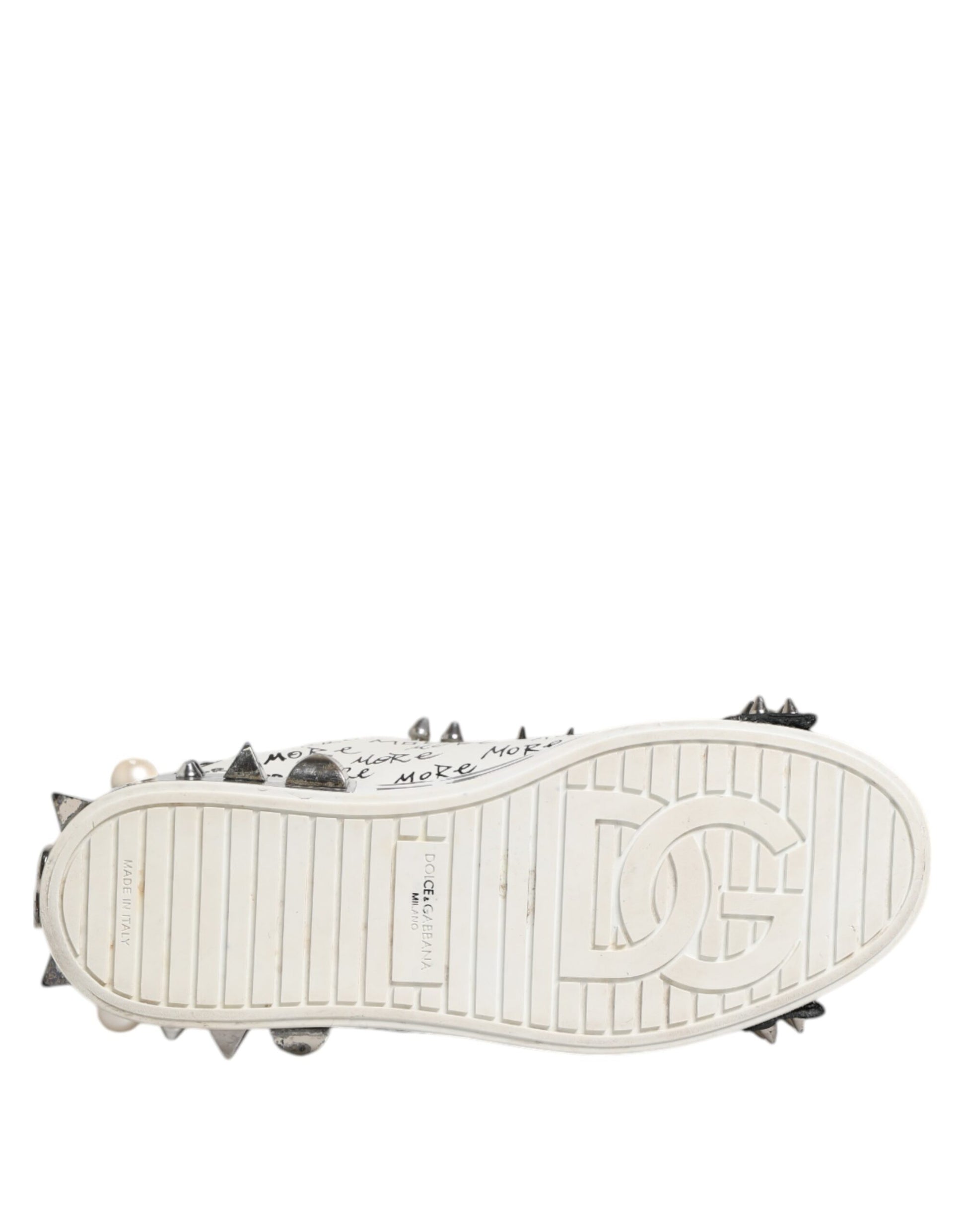 A pair of black and white studded low top sneakers with a logo on the side
