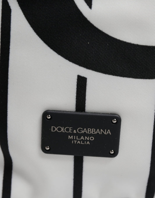 Black tag on white fabric with brand name in gold lettering