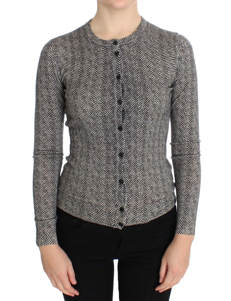 A person wearing a tweed jacket with buttons down the front