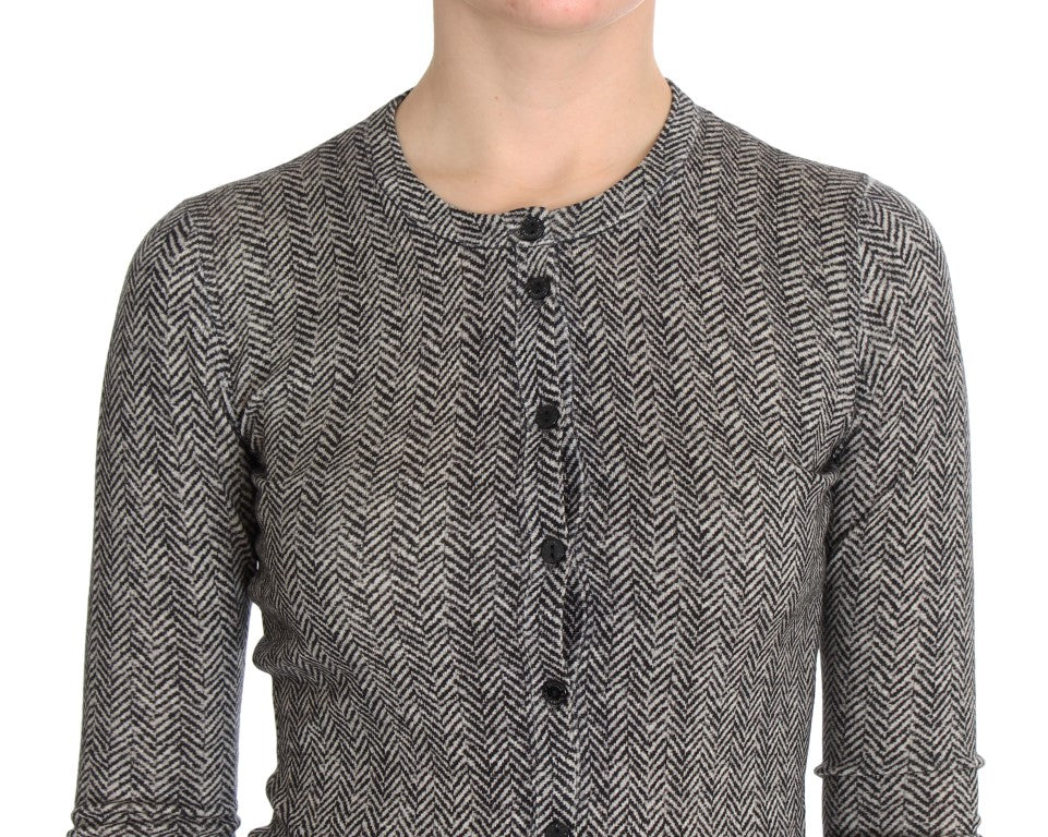 A person wearing a tweed jacket with a herringbone pattern