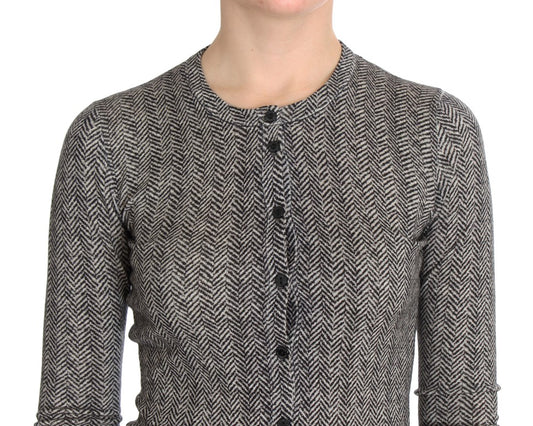 A person wearing a tweed jacket with a herringbone pattern