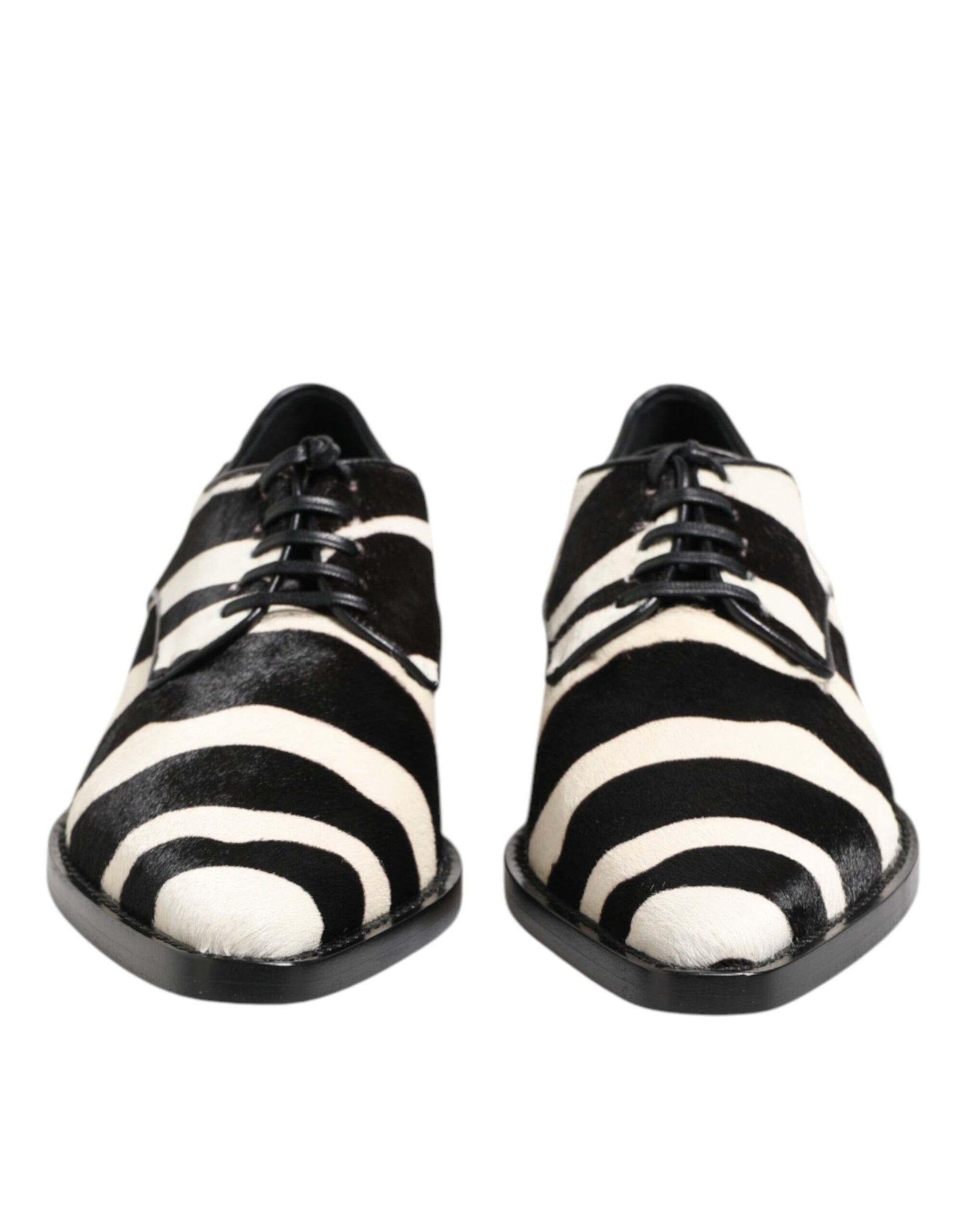 A pair of black and white zebra print shoes with fur trim