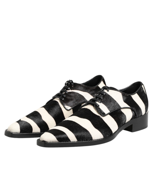 A pair of black and white zebra print shoes with fur trim