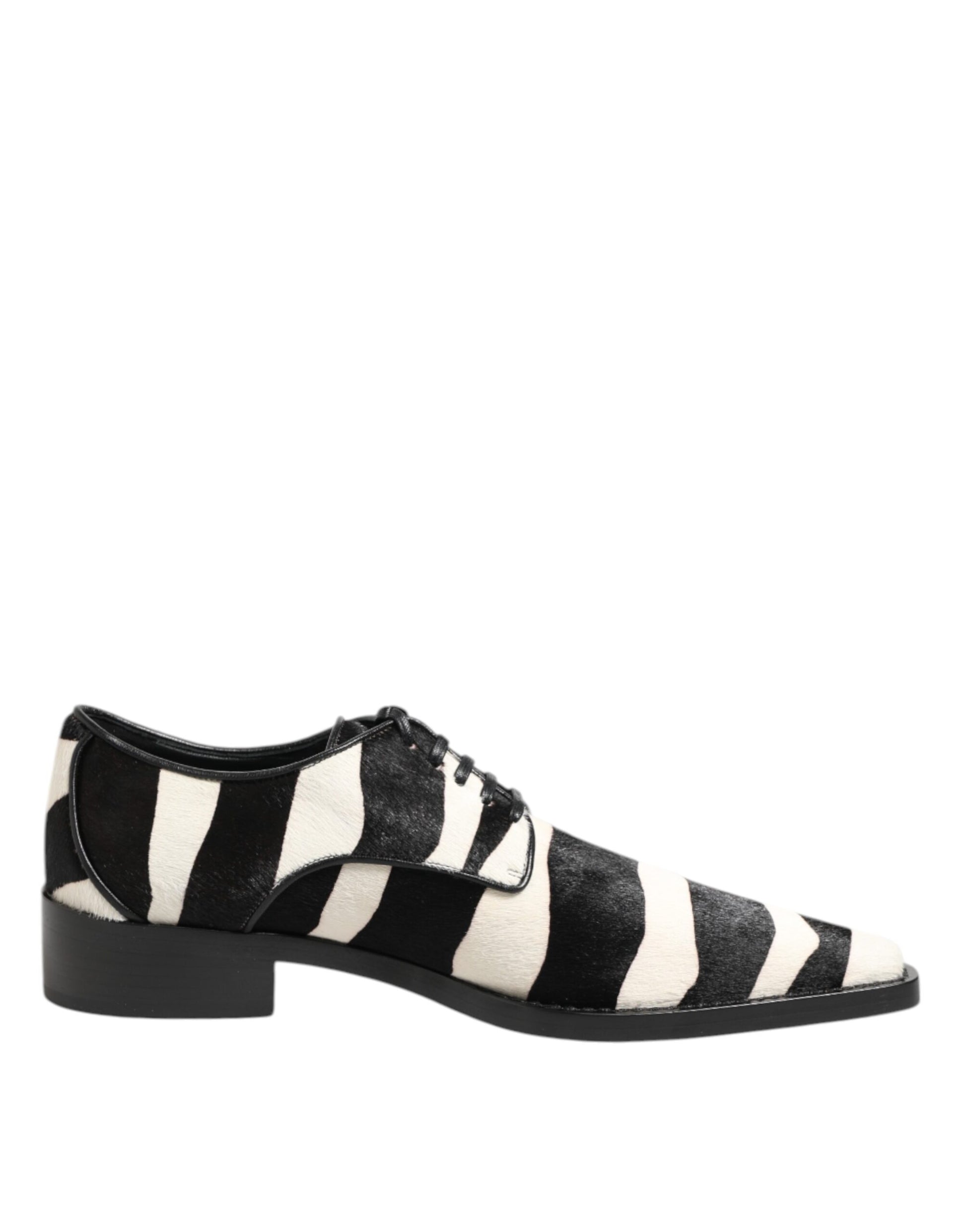 A pair of black and white zebra print shoes with a fur trim