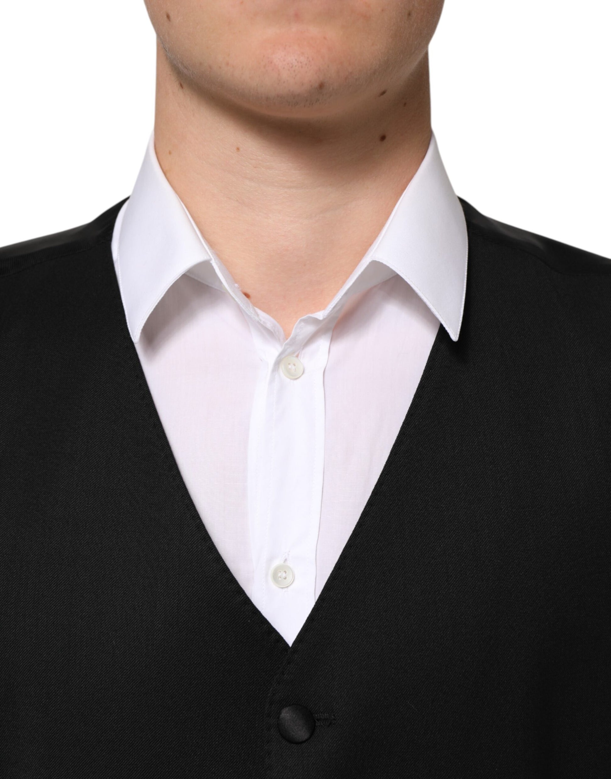 A black wool vest with white buttons, part of a formal men's suit