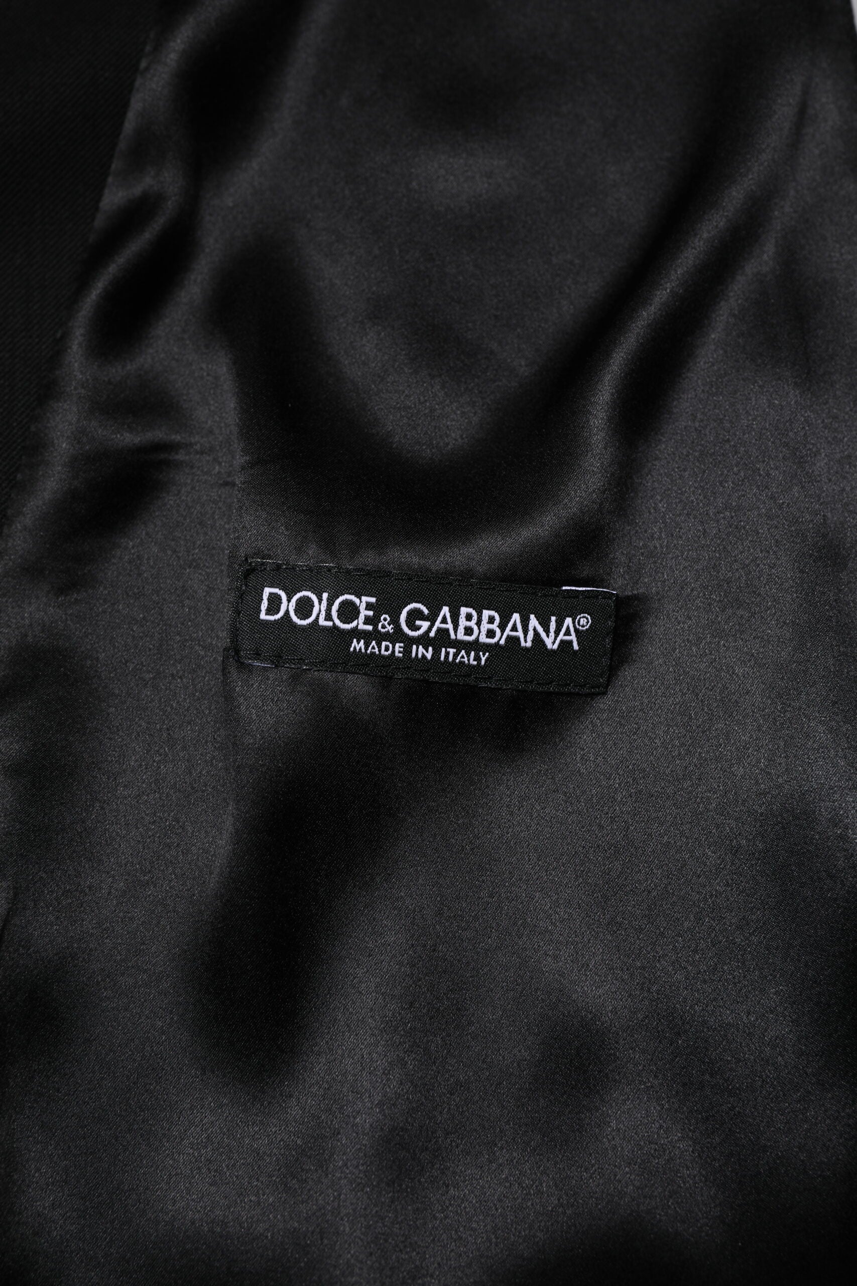 A black wool vest from Dolce & Gabbana, part of a formal men's suit