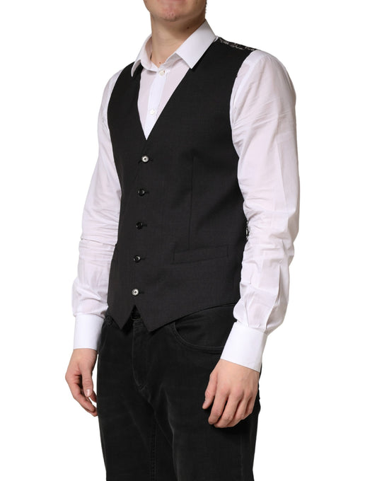 A black wool vest with white shirt and blue jeans