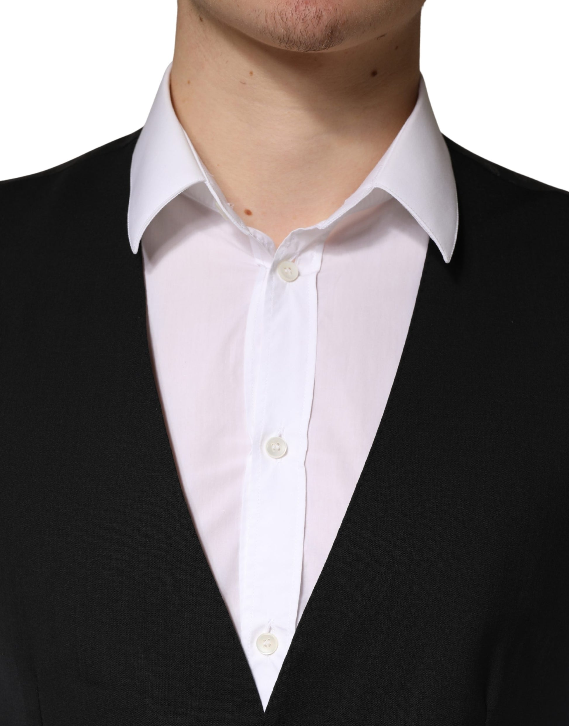 A black wool vest with white buttons, part of a men's formal suit