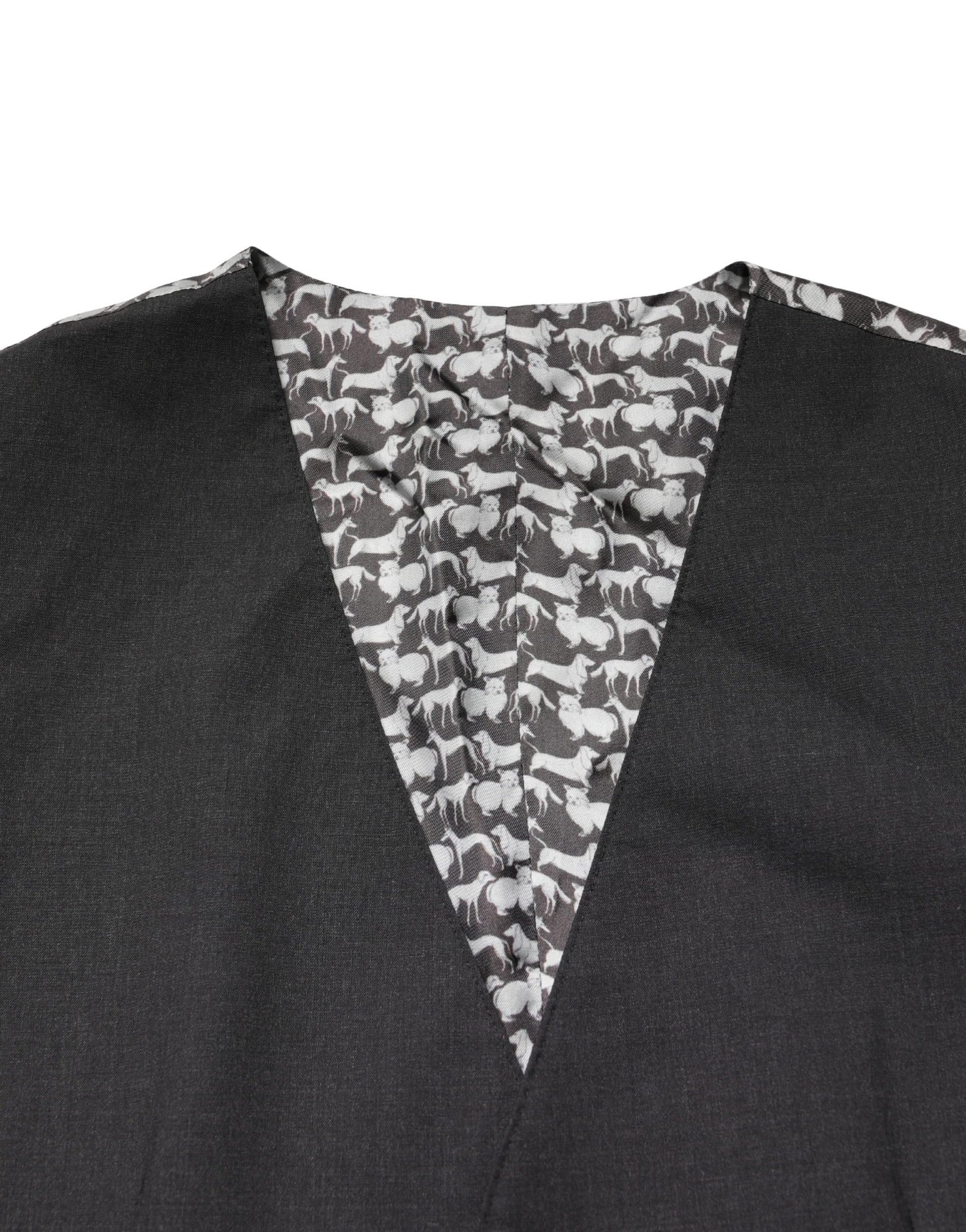 A black wool vest with a pattern of white dogs on the front