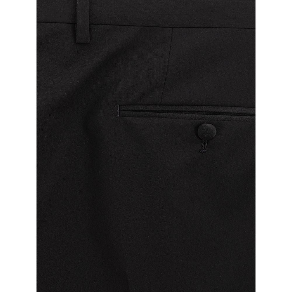 A pair of black wool dress pants with a buttoned front pocket and a belt loop on the waistband