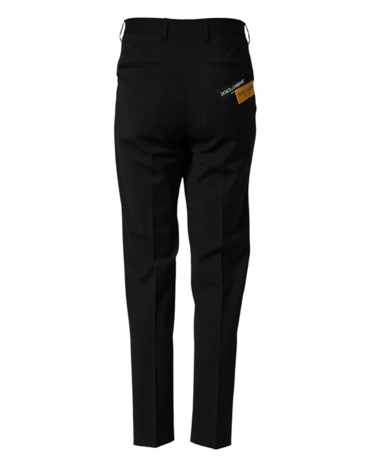 A pair of black wool formal dress pants with a label on the waistband