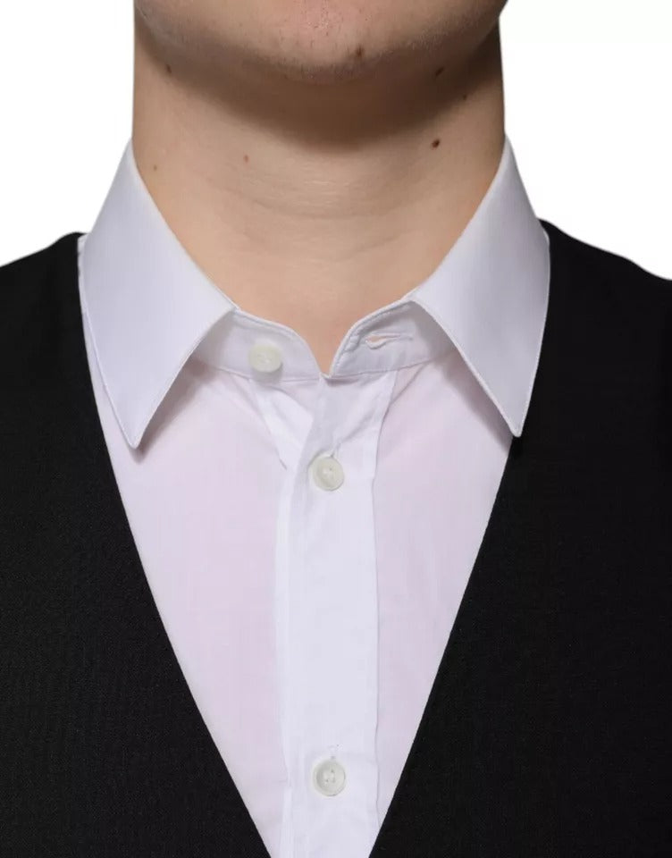 A black wool vest with white buttons, part of a formal men's suit
