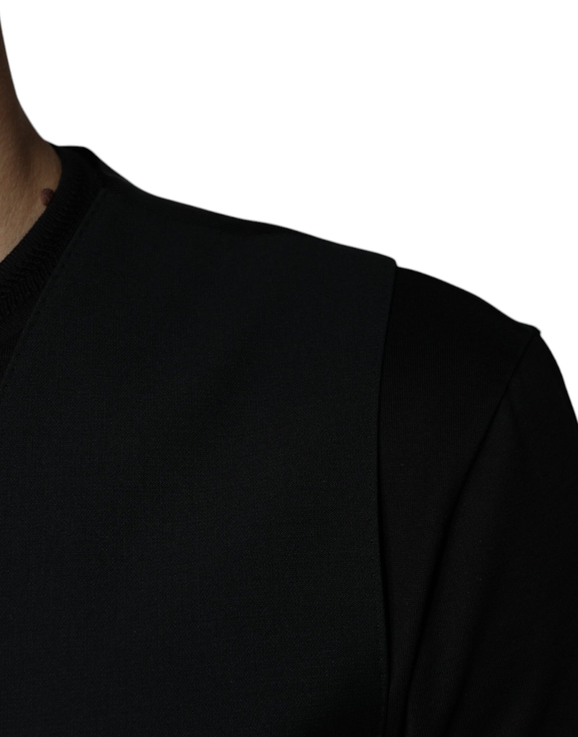 A black wool vest with a ribbed neckline and cuffs
