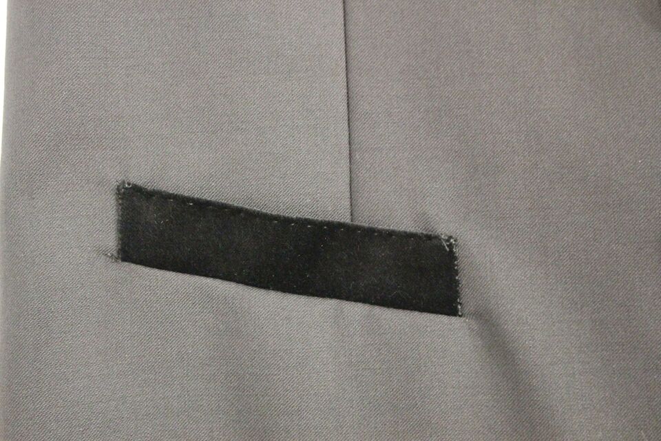 A black wool vest with a label on the left side