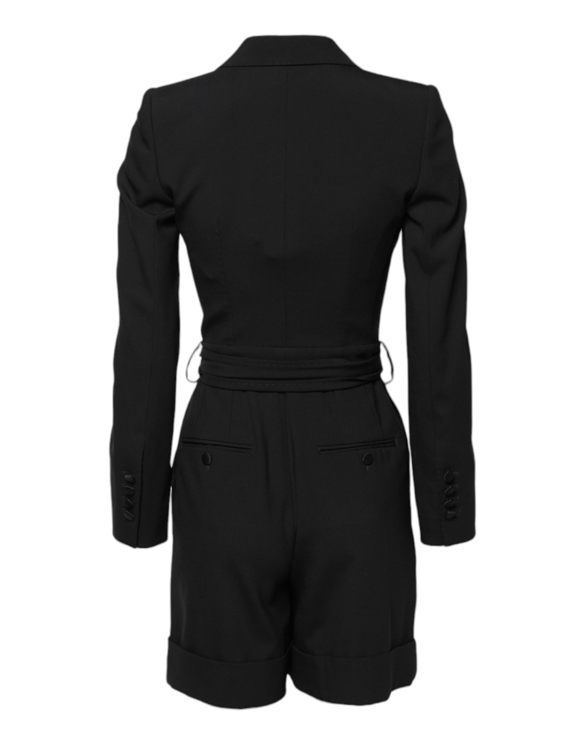 A black wool jumpsuit dress with a fitted waist and long sleeves
