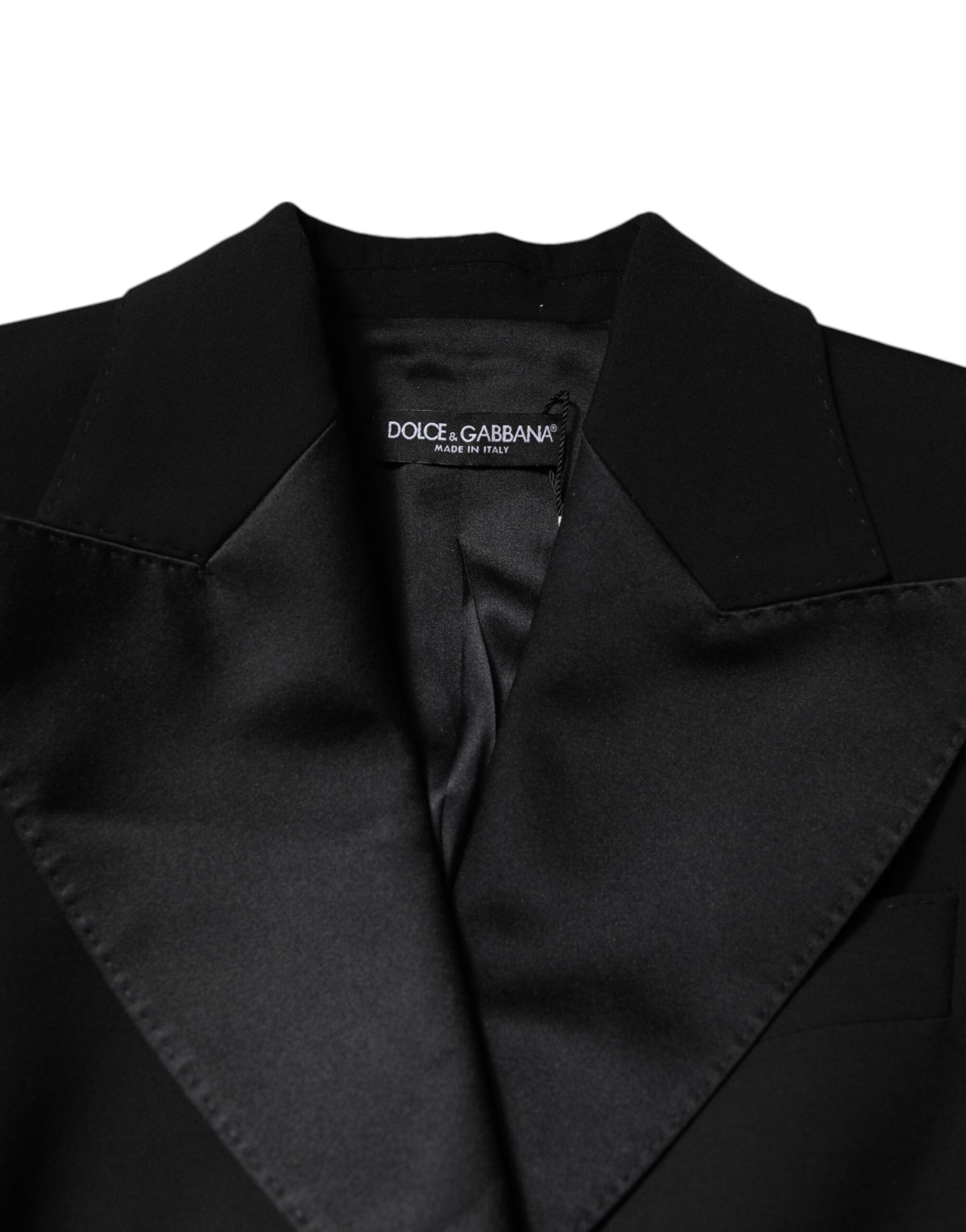A black wool jumpsuit dress with a V-neckline and a fitted waist
